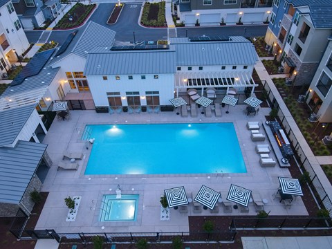 Drone View of Pool at Night with Apartment Exteriors